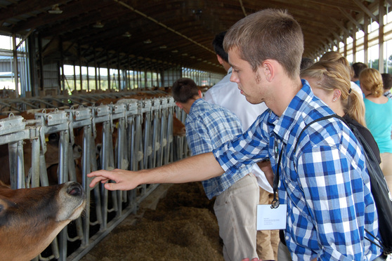 national 4-h dairy conference​​ members tour cattle feed barn
