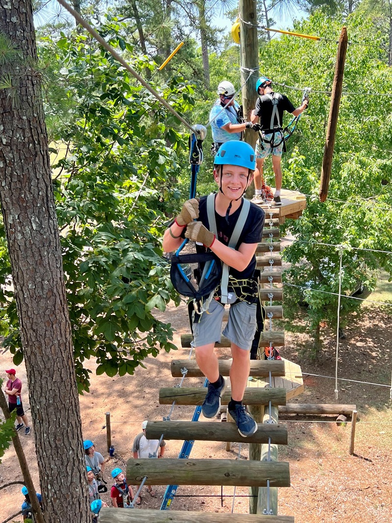 Camper walking on a high ropes course