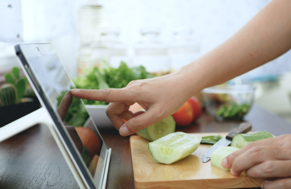 person cutting a cucumber