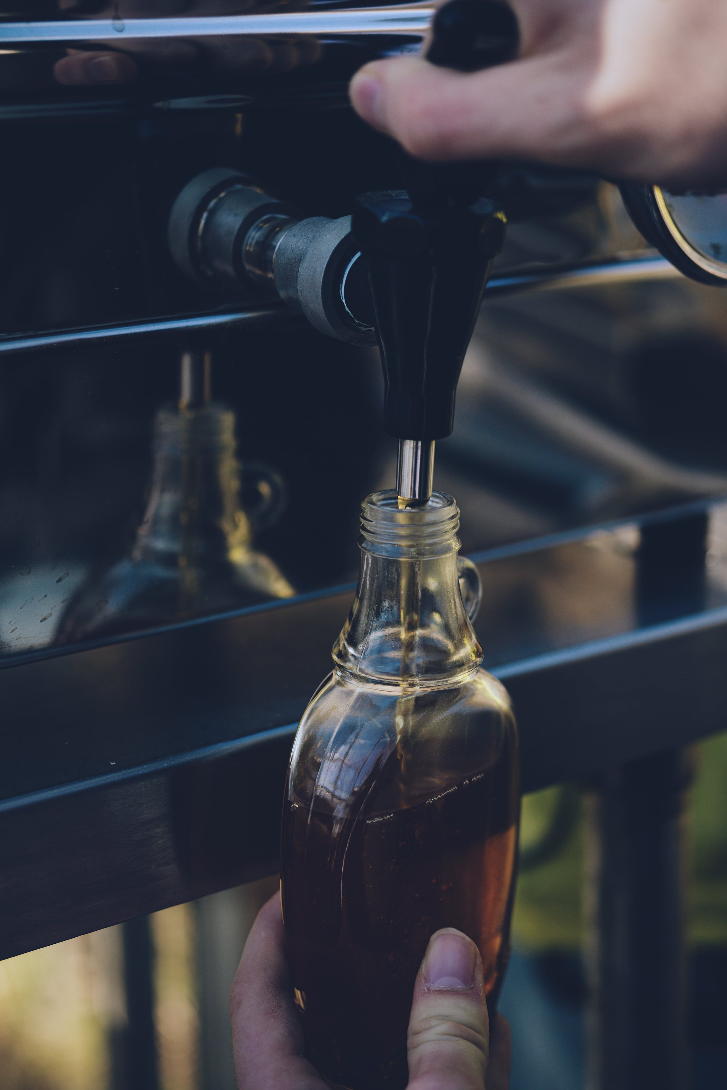 Image of a bottle being filled with Maple Syrup
