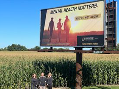 Billboard in Garrett showing farm family in field stating Mental Health Matters You're Not Alone