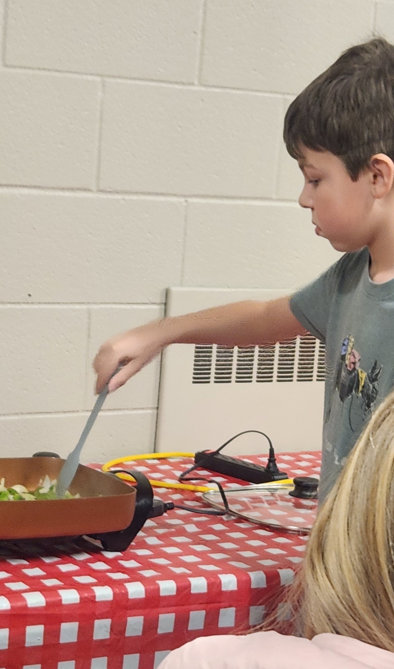 Child cooking with pan