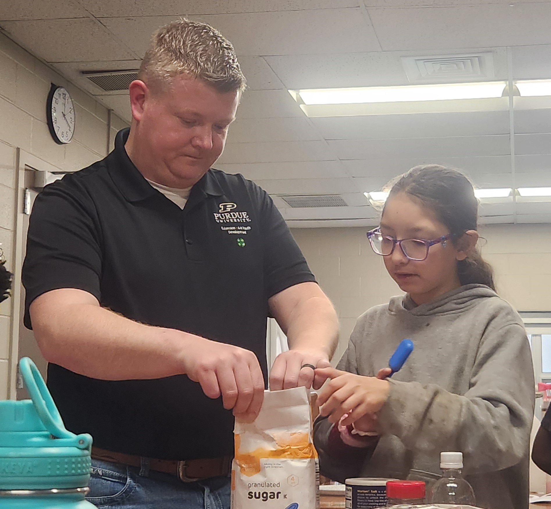 Student and Educator Measuring Sugar