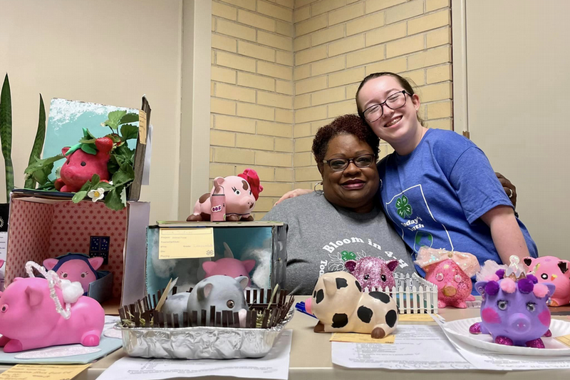 4-H Volunteer woman smiling with Child