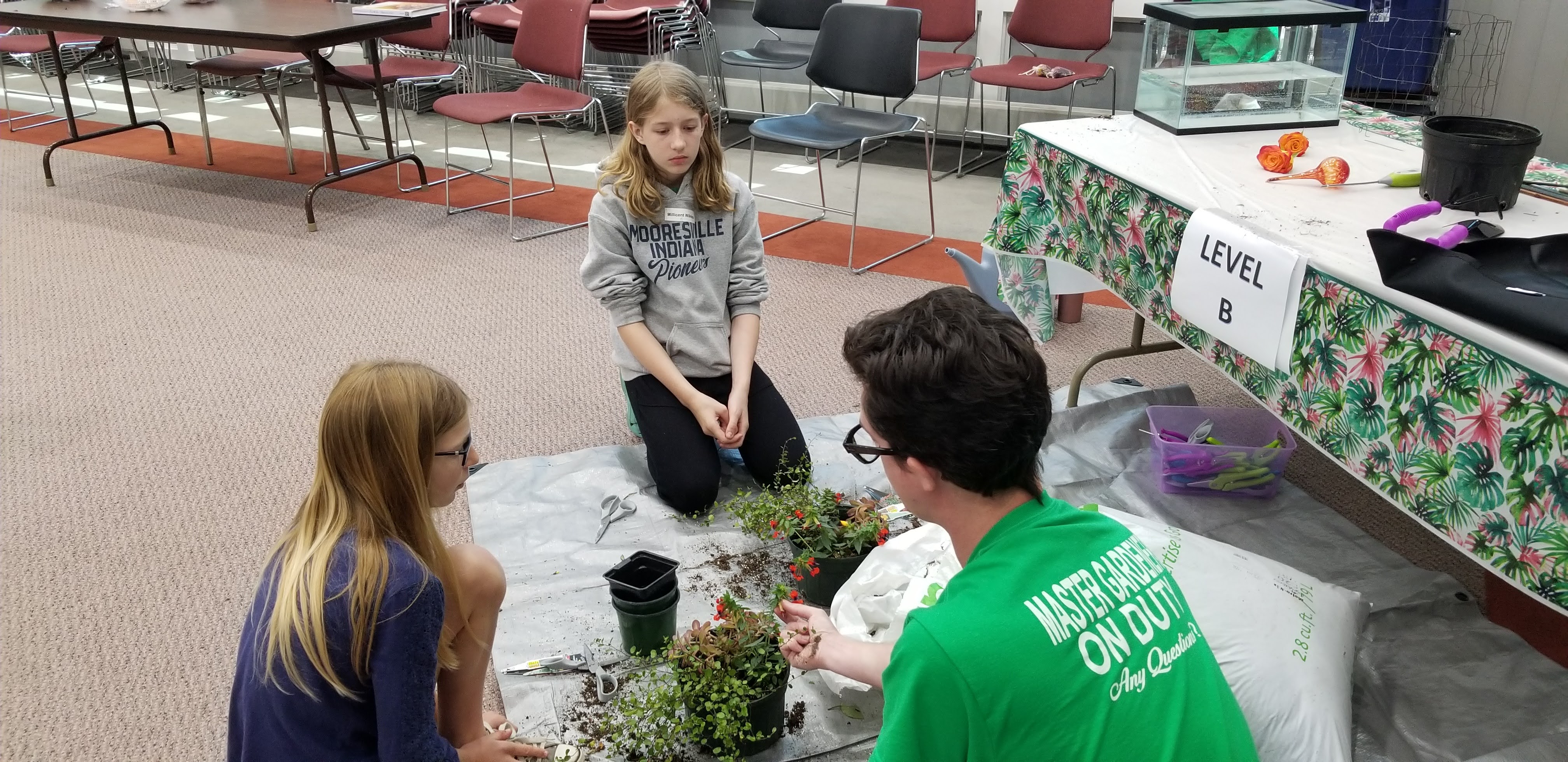 Morgan County Master Gardener Teaching 4-H Youth How to Plant a Mixed Planter