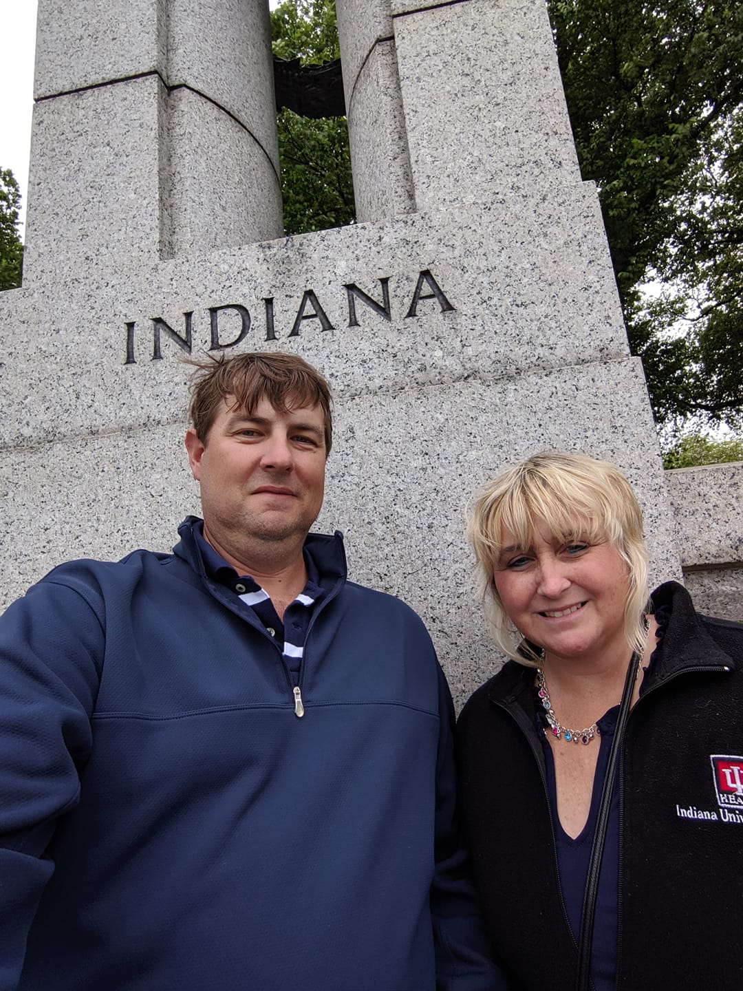 Jason and Katie Maxwell standing in front of Indiana sign