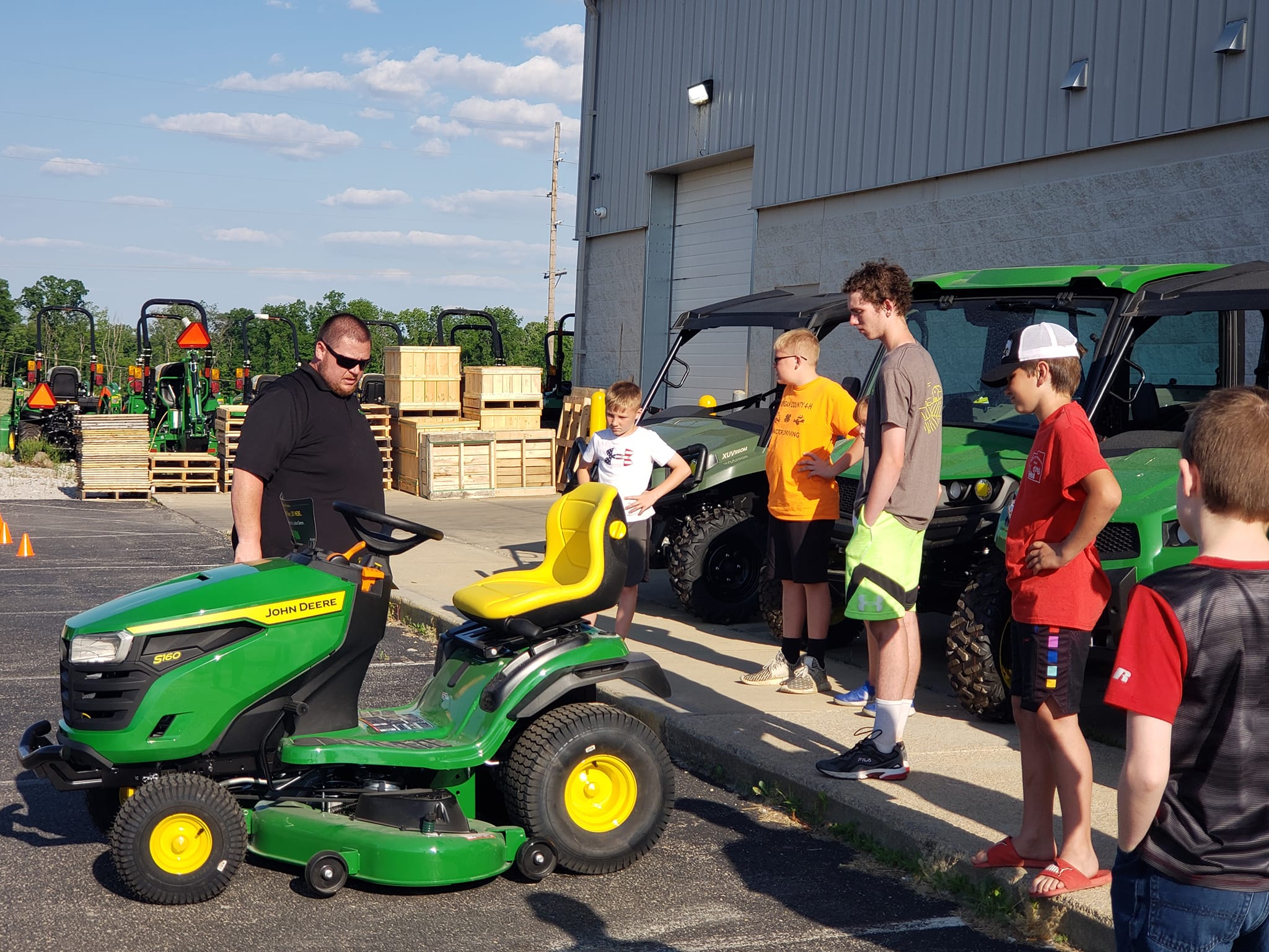 Tractor Club Members learning about a John Deere S160  Riding Lawn Mower