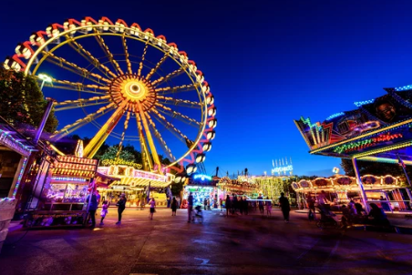Farris wheel and colorful lighted stands