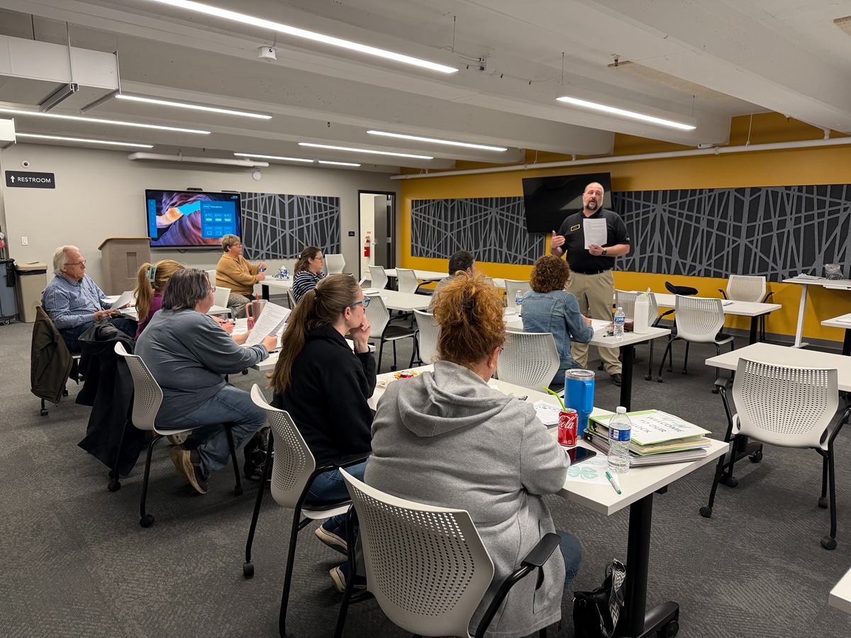 4-H youth training alt text: A 4-H educator presents to 4-h volunteers