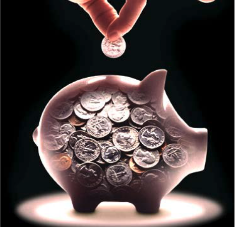 a hand adding a coin to a piggy bank