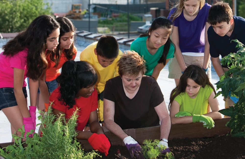 Woman doing gardening with teens