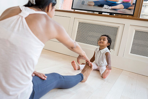 Mother exercising with her toddler 