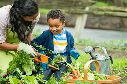 Mother doing gardening with her child