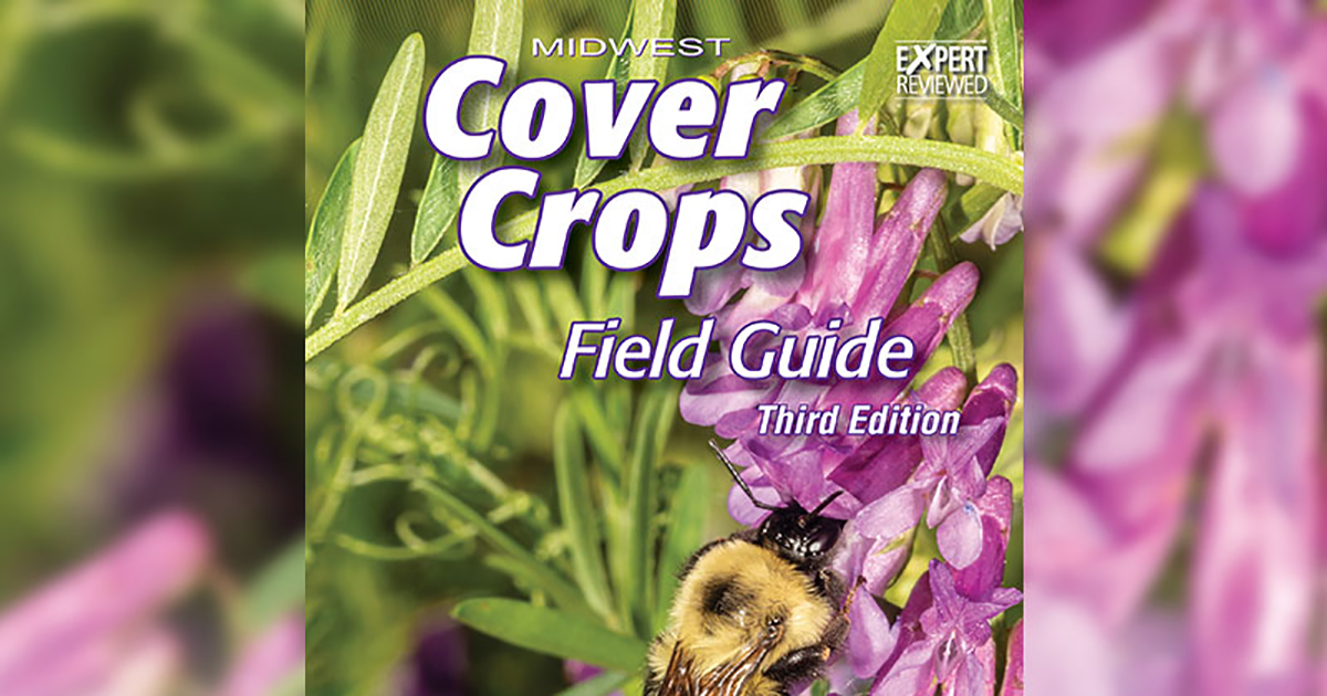 Cover of the new edition of the Cover Crops Field Guide. Bee on flower.
