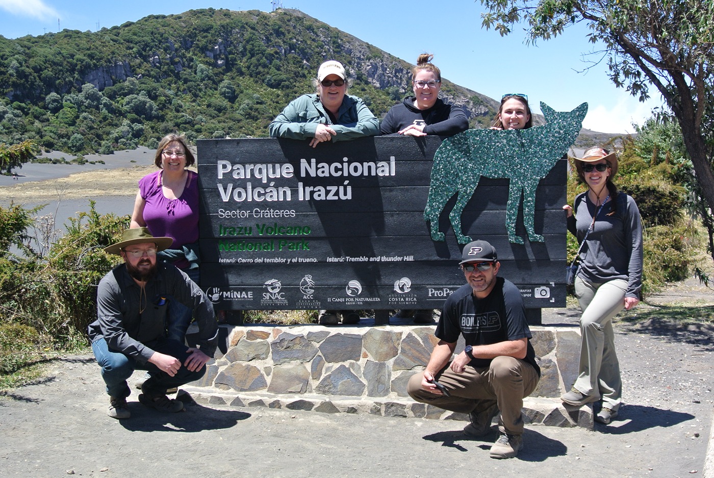 Group of Purdue Extension agriculture and natural resources educators around Parque Nacional Volcan Irazu sign in Costa Rica.
