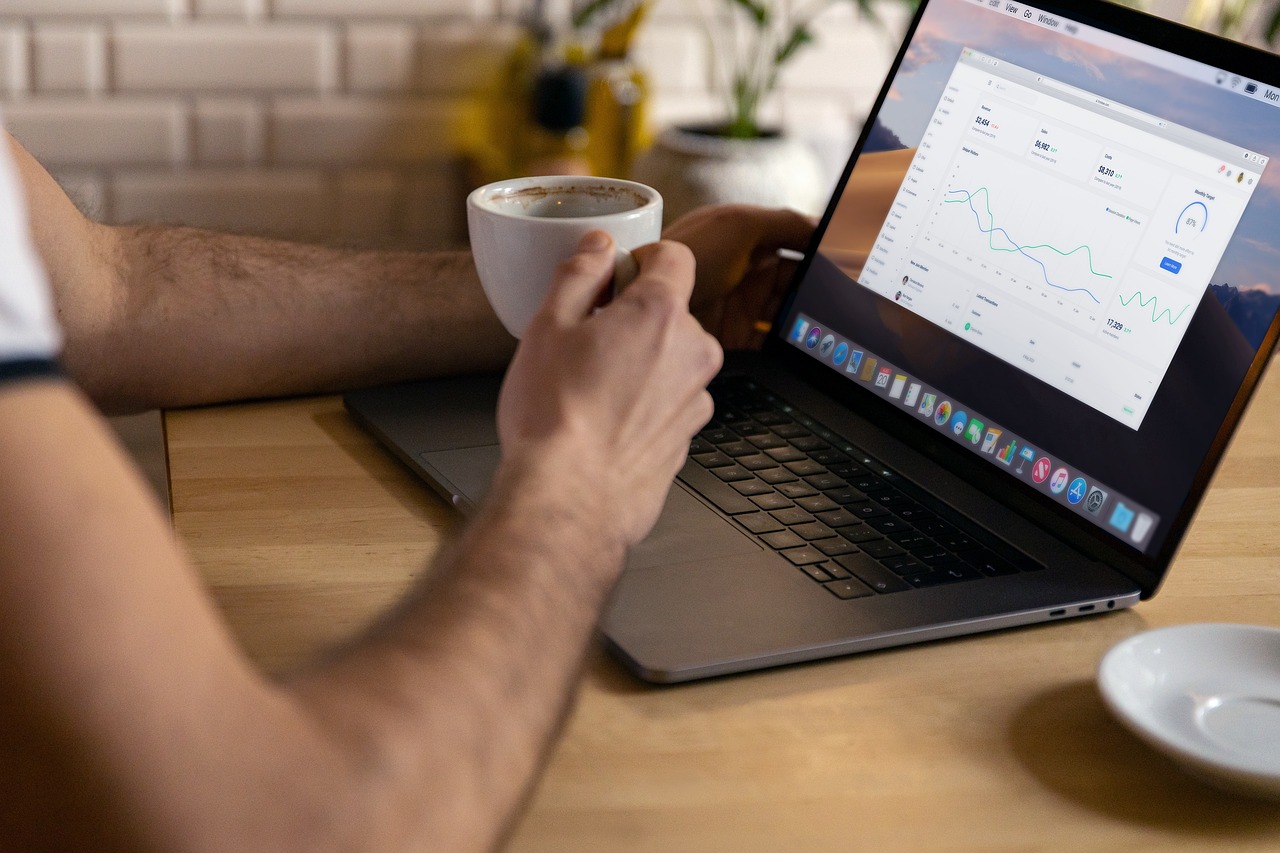 remote work, man drinking coffee with laptop working