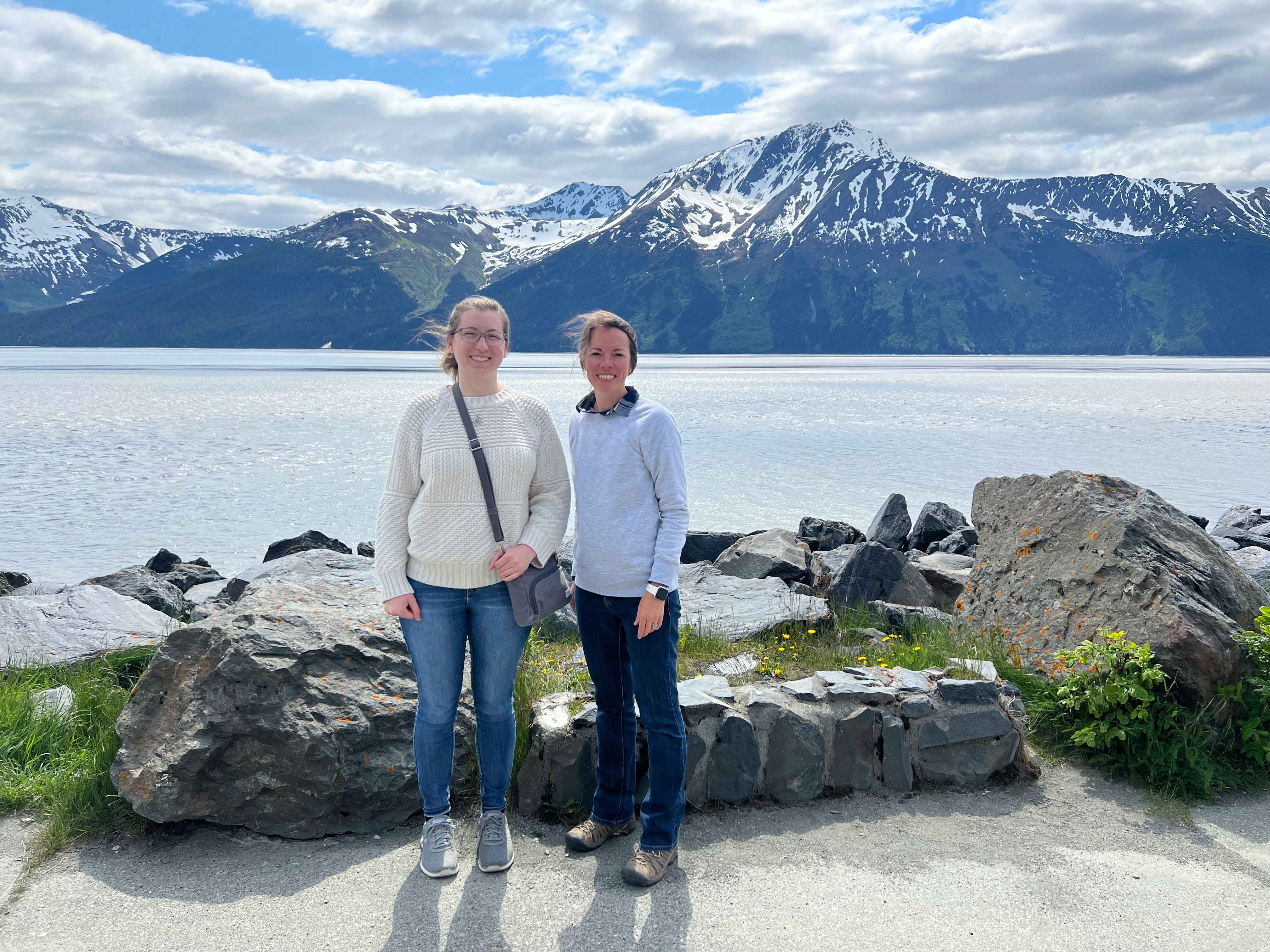 Two Indiana 4-H educators in front of Alaskan mountains.