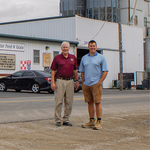 Lynn Stieglitz and his son Jeremy standing in front of Milan  Center Feed and Grain in Northeast Indiana