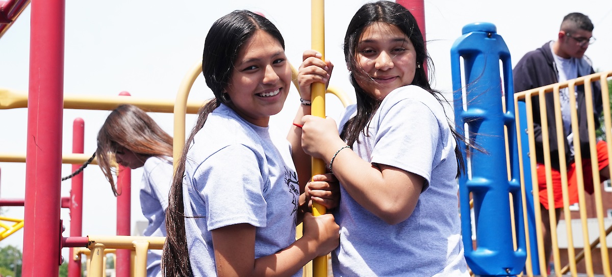 two juntos 4-H girls enjoying time on a playground