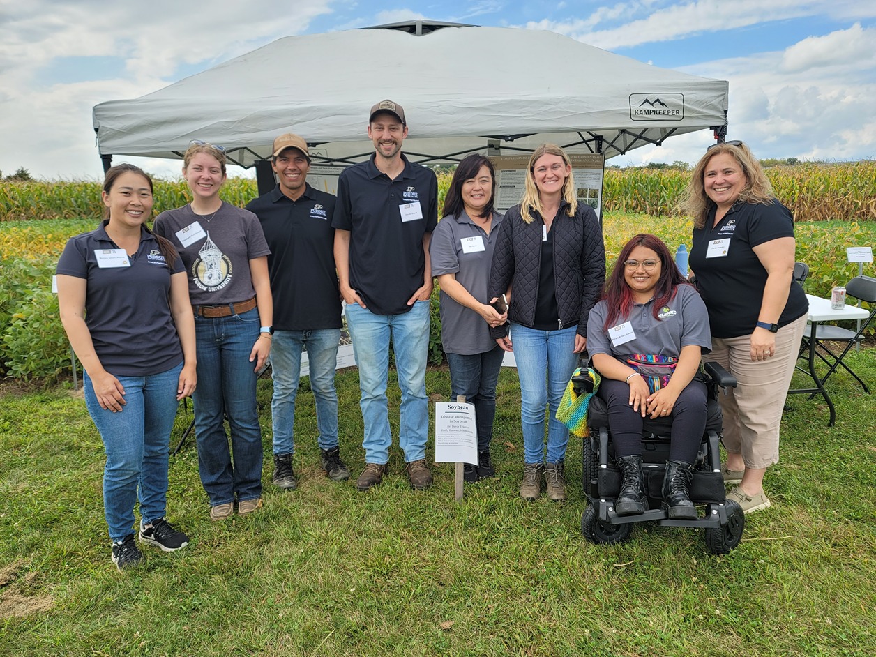 Part of the Telenko Lab poses at demonstration plots for ACRE 75th.