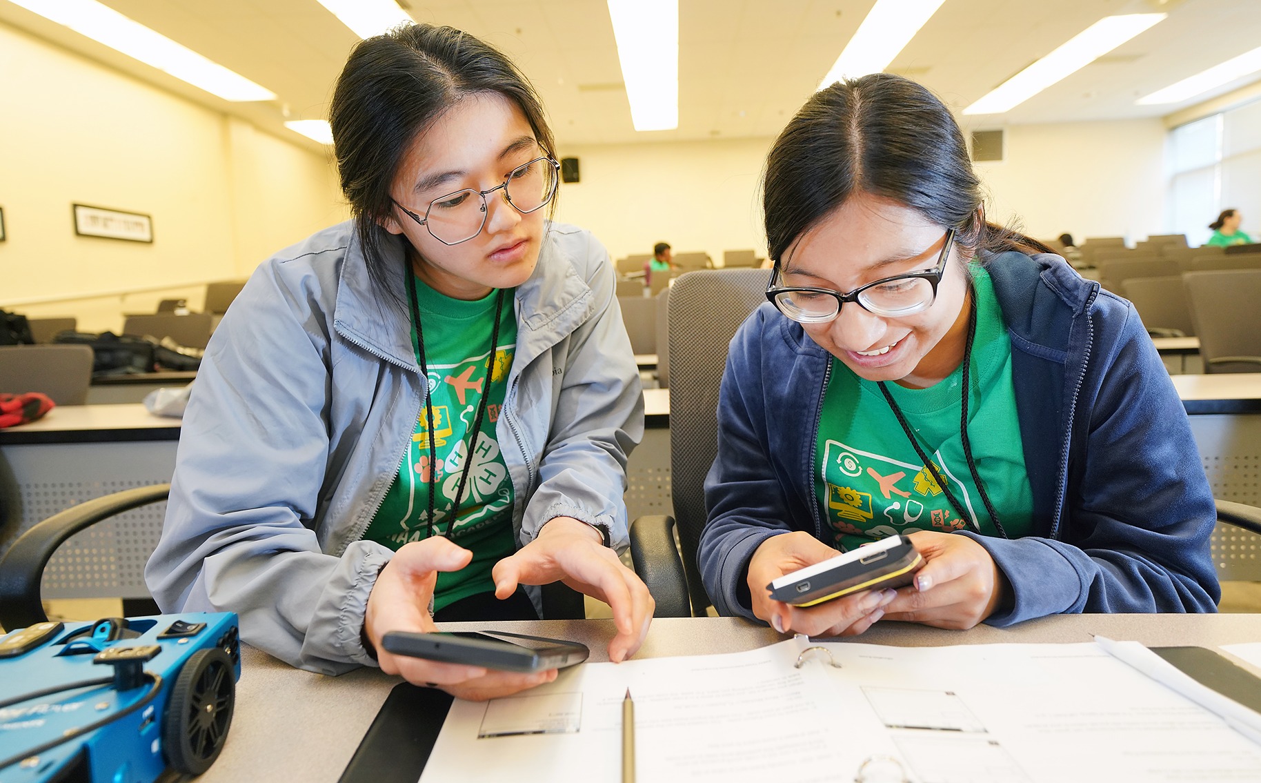 Two 4-H youth helping one another with homework.