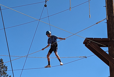 Indiana teen trying the tight rope at adventure camp.