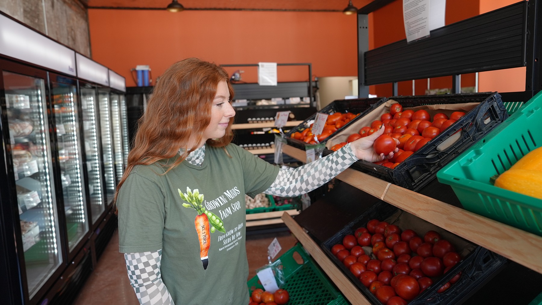 Lilly Cox restocking produce shelves
