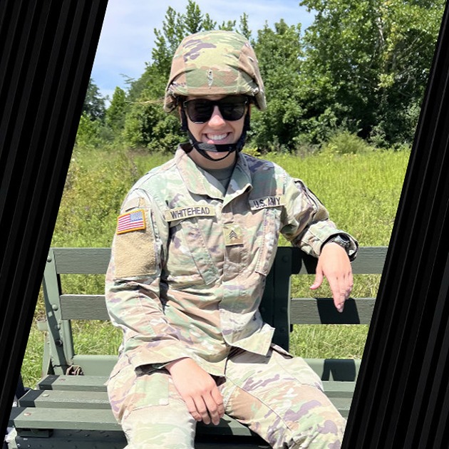 A veteran in his military uniform is smiling.