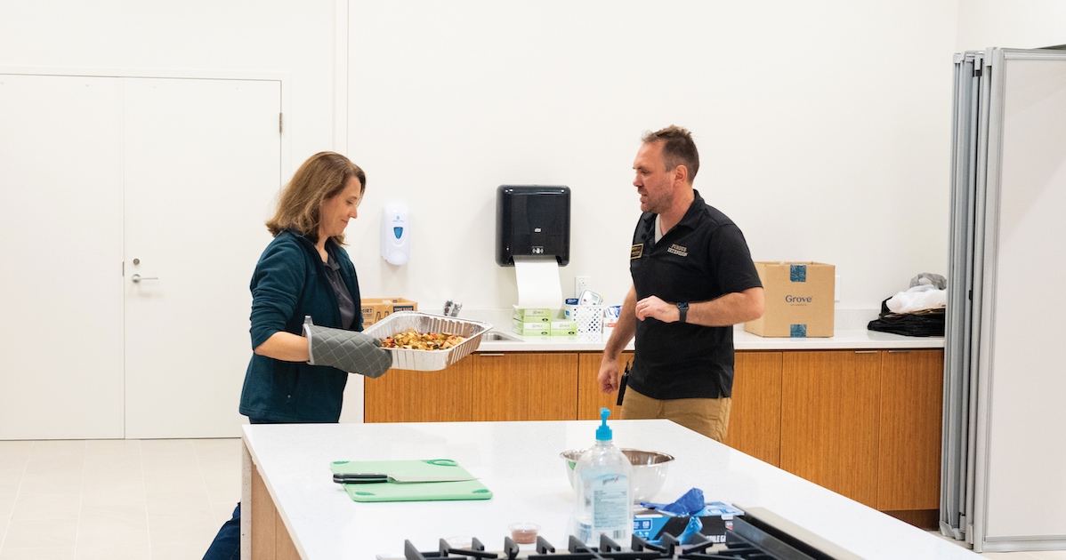 a couple cooking in a kitchen