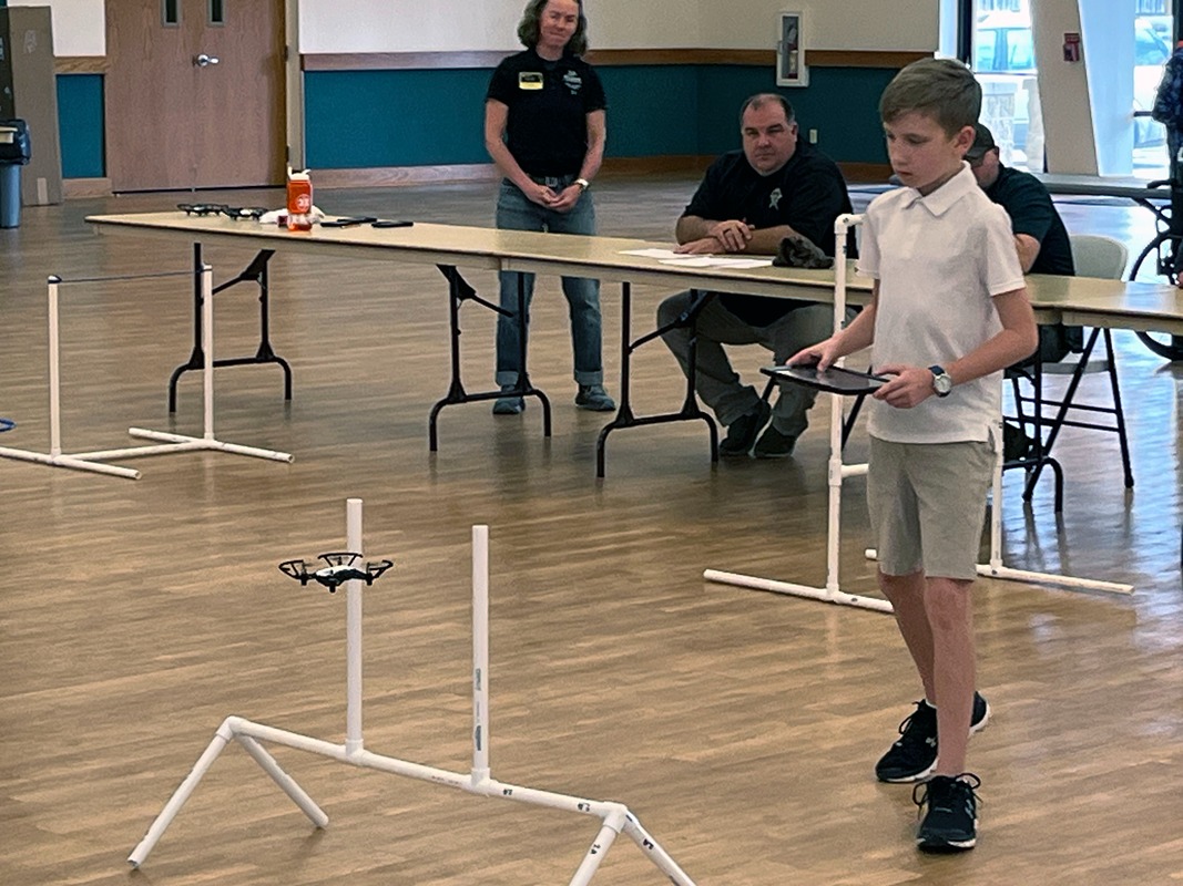 A participant from the 2025 UAV/Drone competition navigates a drone through an obstacle course. (Photo provided)