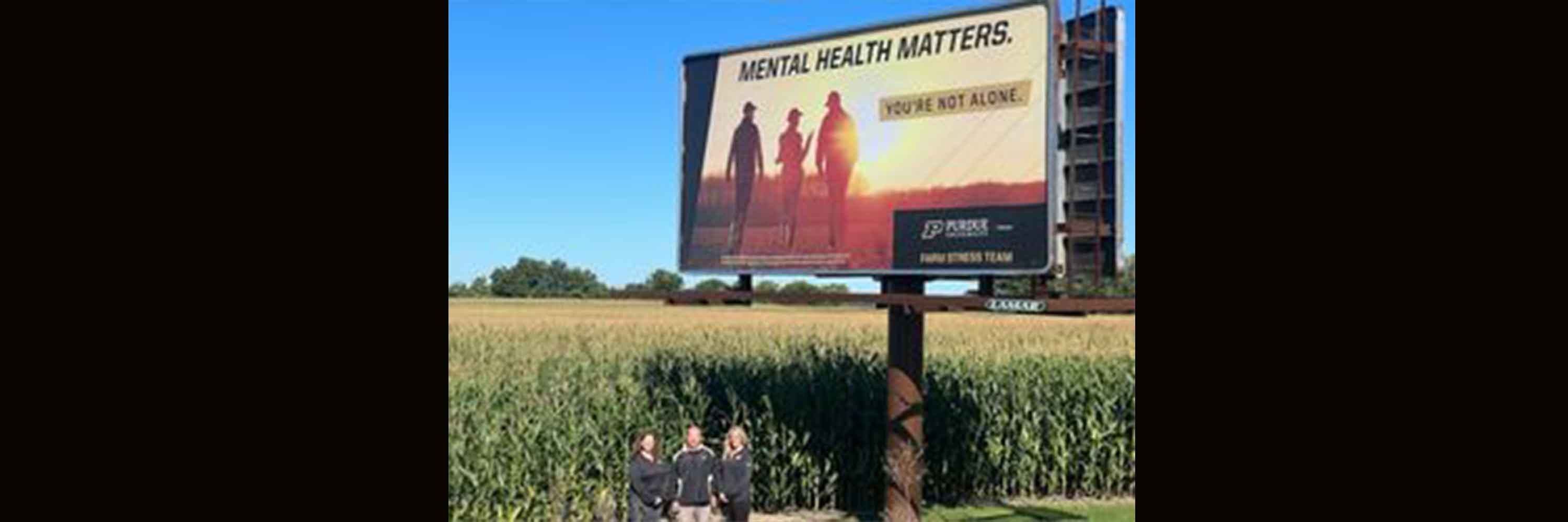 picture of Farm Stress Billboard in Garrett that shows farm family in field and says Mental Health Matters You're Not Alone