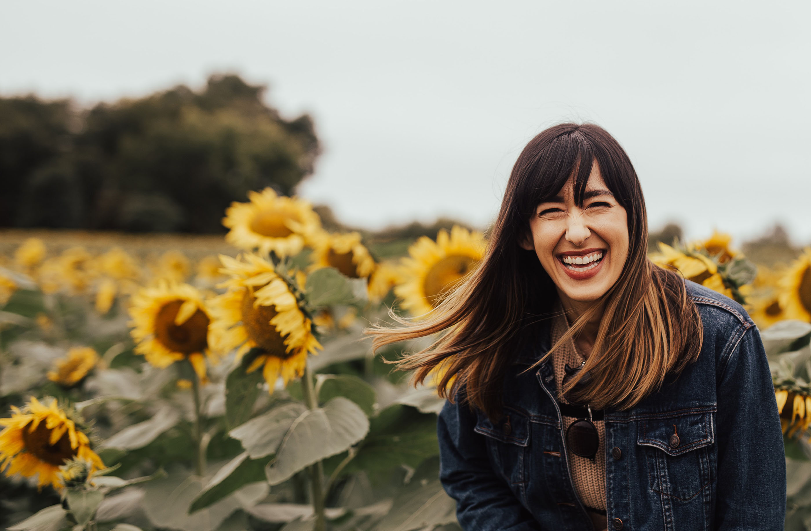 girl smiling in sunflower field