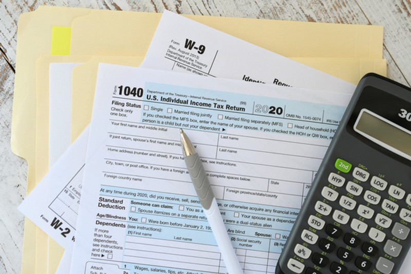 tax forms with calculator and pen