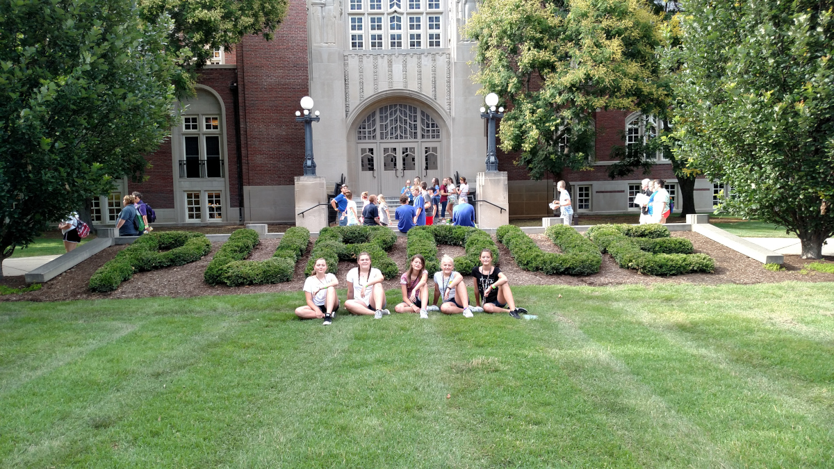 members lounging on the grass outside Purdue's memorial union