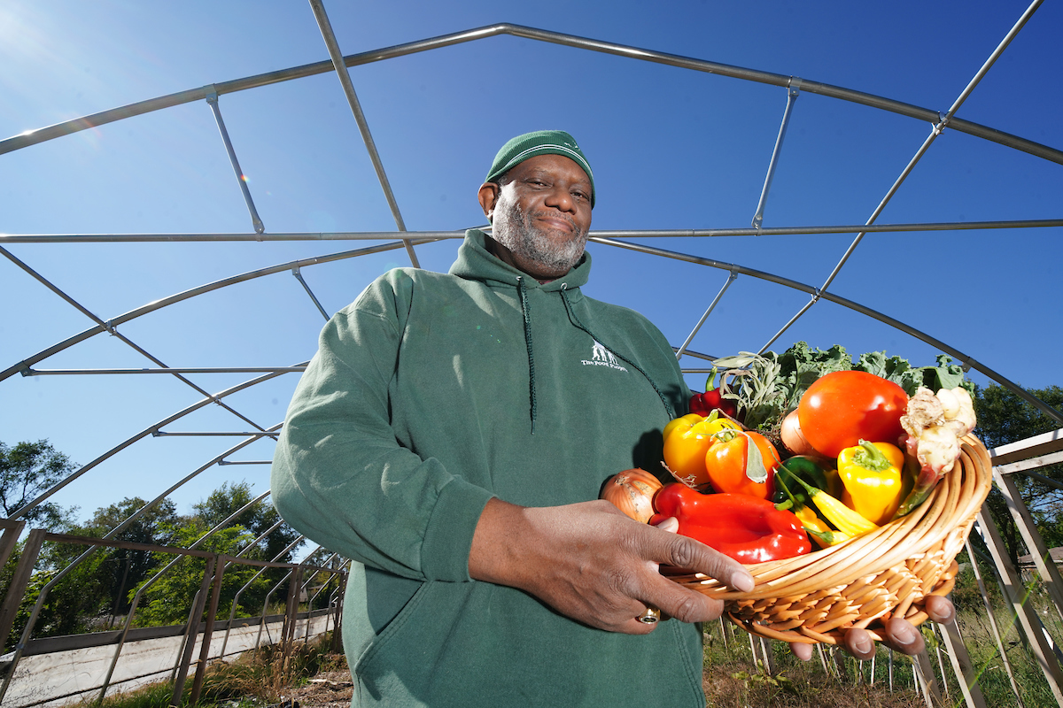 man holds basket of vegetables