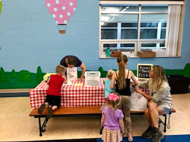 children at a picnic table doing activies