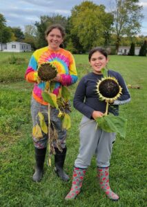 sisters holding sunflowers