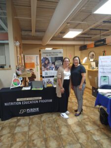 two people next to a conference booth