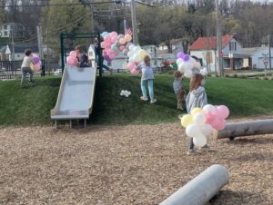 new park with balloons and people