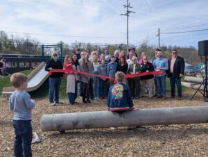 group holding the grand opening ribbon at the park