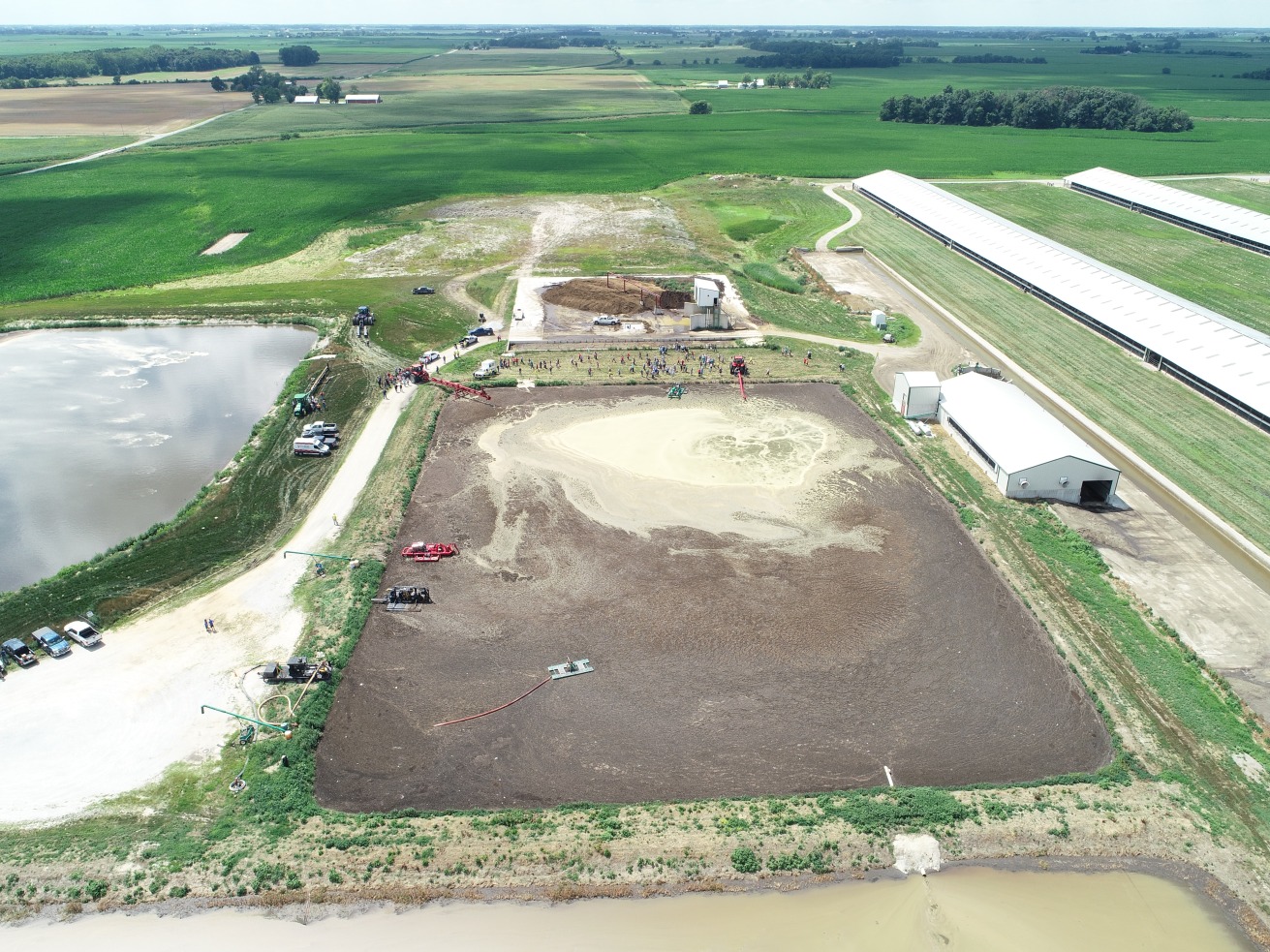 overhead drone image of manure management equipment in a lagoon