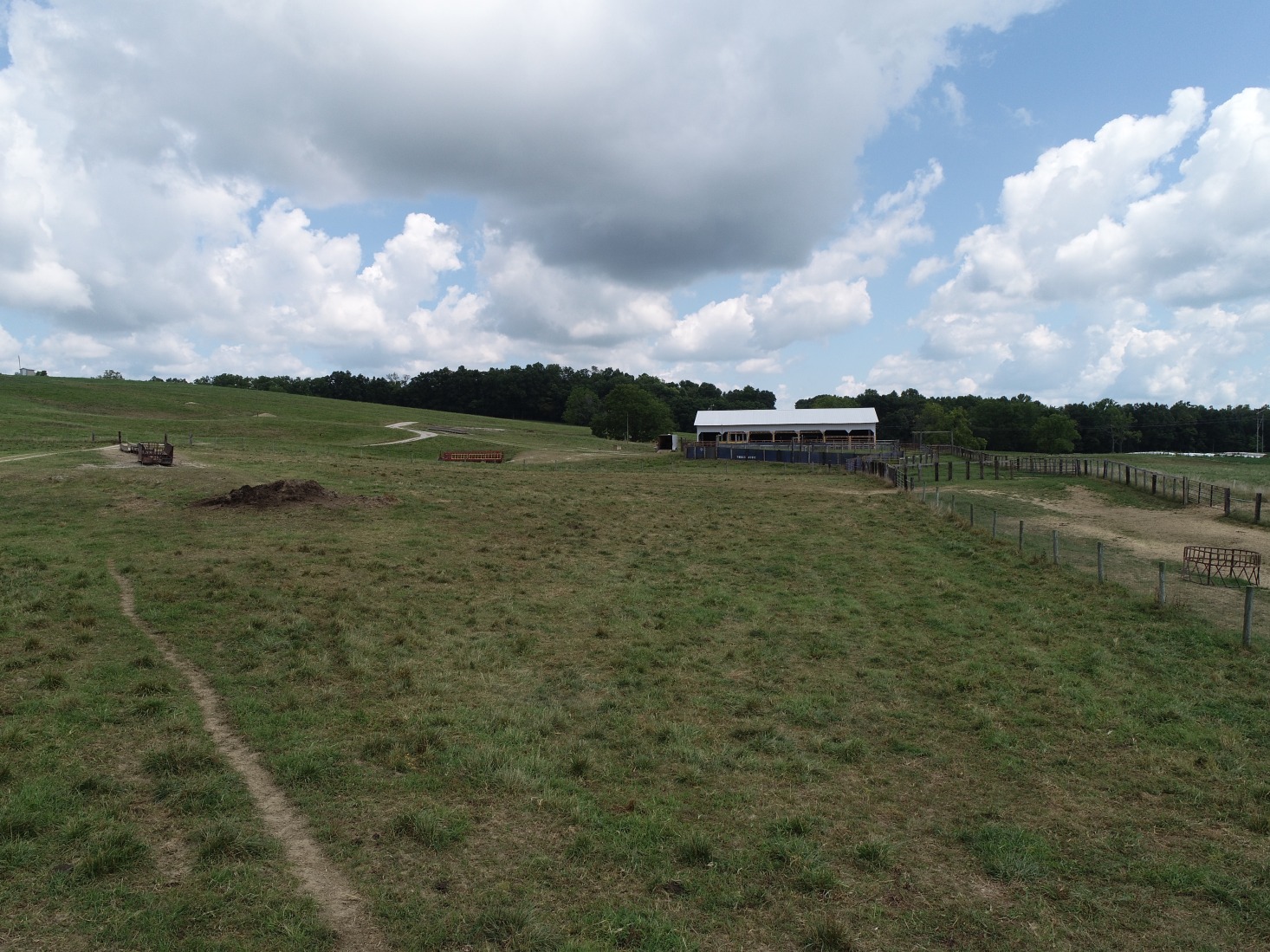 uav drone base station and barn beyond grazing area