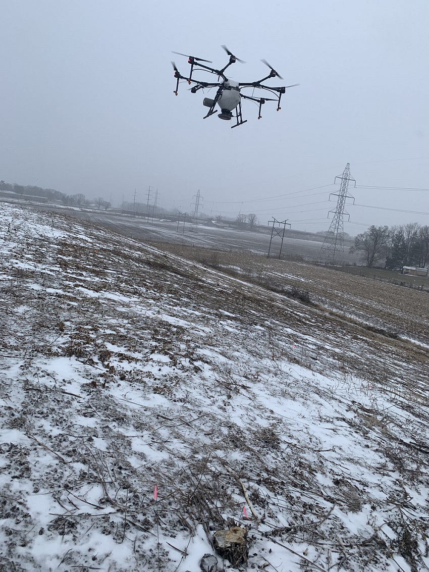 Image a drone flying over a field with snow