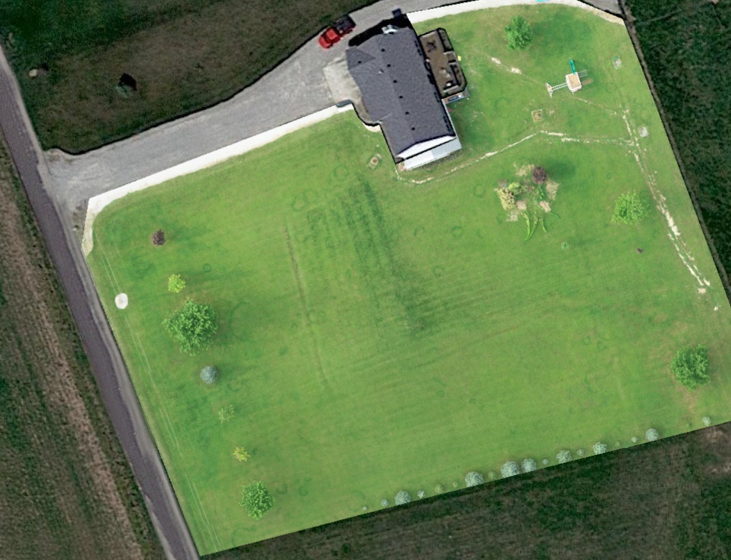 Image of a house with lawn before mowing 